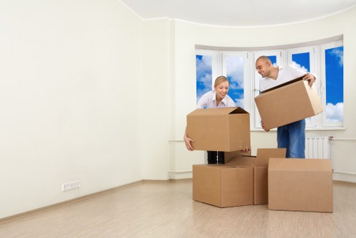 Removal team handling furniture in a Stratford apartment move