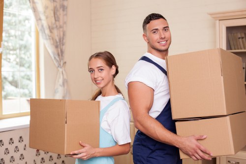 Moving crew carrying items through a shared building corridor